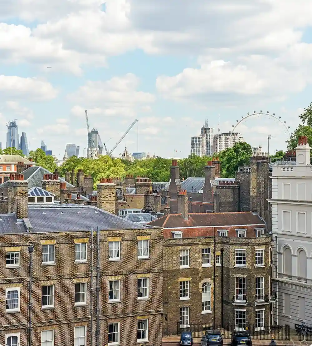 View over London rooftops towards the city skyline and the London Eye